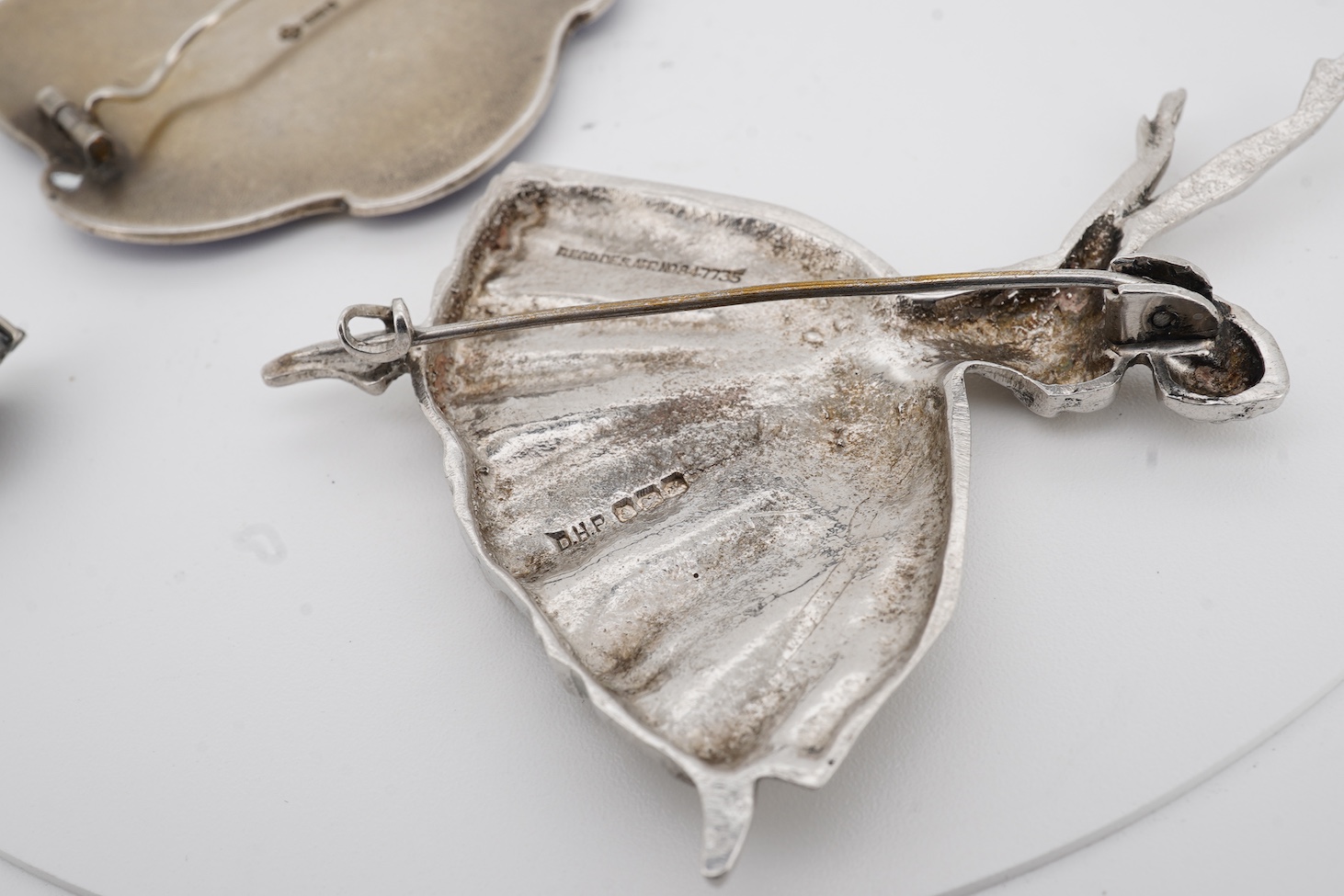 An early to mid 20th century Norwegian 925S and two colour enamelled, brooch, by Ole Nicolai Olberg, depicting three seagulls, 51mm, together with a silver ballerina brooch by D H Phillips Ltd, Birmingham, 1947, a sterli